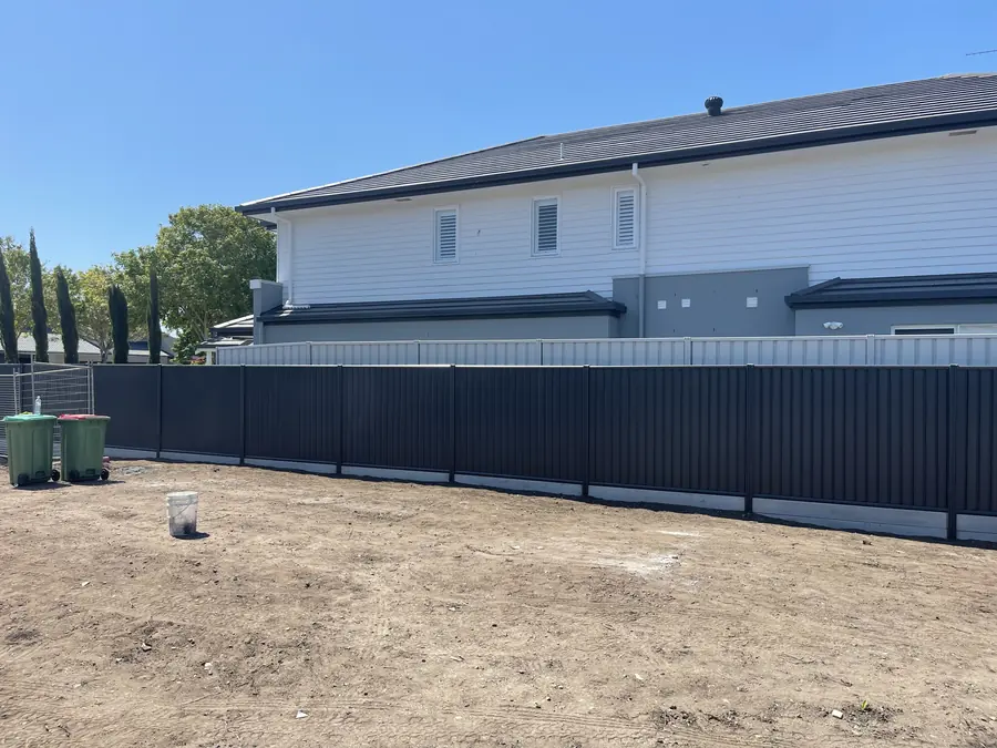 Long run of charcoal Colorbond fencing at a new duplex build