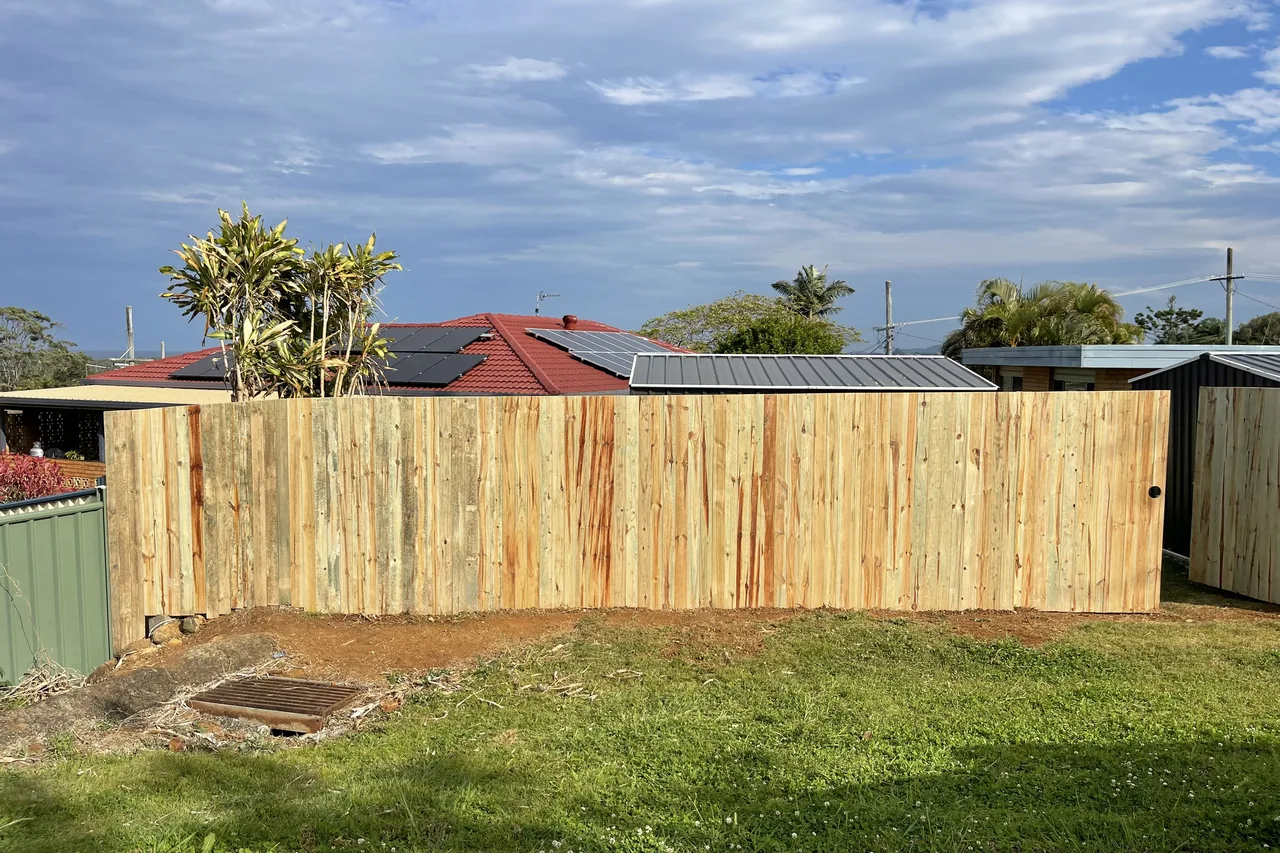 New treated pine paling fence along a backyard boundary